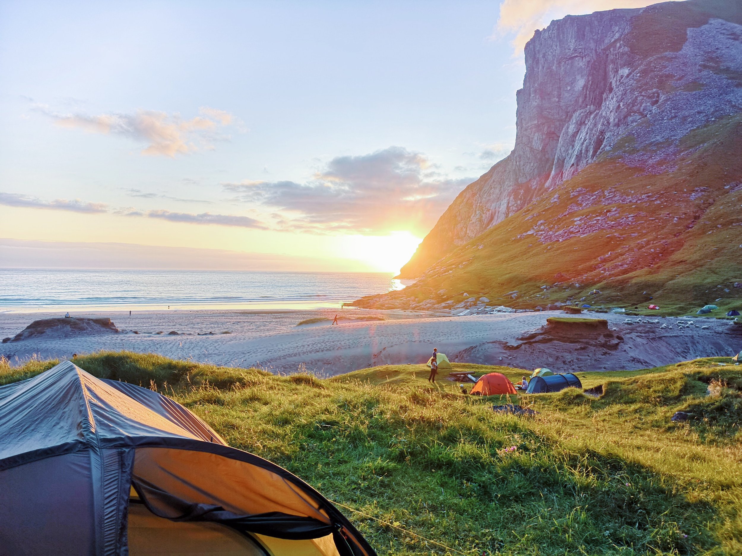 TentBox camping setup above a coastal campsite at sunset